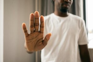 A person holding their hand up, maintaining their PSB boundaries