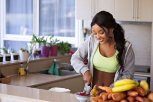 A woman prepares a nutritious meal, focusing on holistic recovery methods.