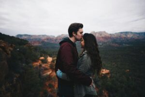 A couple embracing closely in nature, symbolizing trust, connection, and intimacy built on healthy boundaries after recovery.