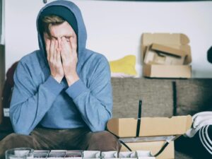 A man covering his face at a addiction treatment center