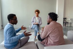 A couple arguing in front of a therapist during sex addiction treatment in Idaho