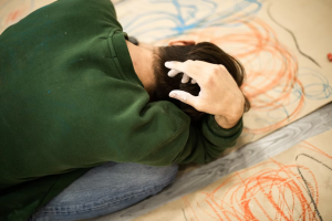 Man on floor in a green sweater