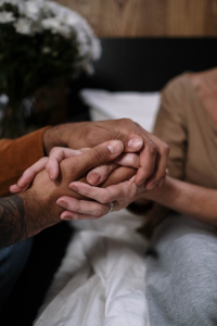 Two people holding hands, symbolizing trust and reconnection in the healing process after sex addiction.