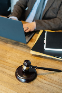 Wooden gavel resting on a wooden surface, symbolizing legal consequences of online sexual behavior.