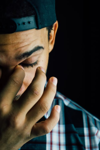 An image of a man wiping his tears