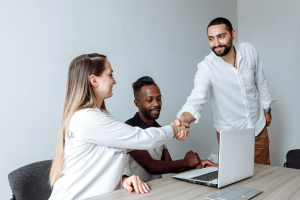 An image of a man shaking a woman’s hand