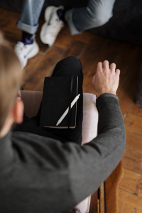 An image of a man with a journal on his lap