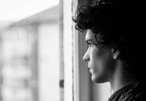 An image of a man looking out of the window