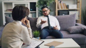 Male patient participating in a therapy session as part of a court-mandated inpatient addiction program.