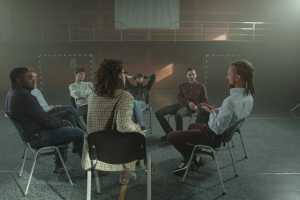 Men participating in a structured inpatient therapy session for sexual addiction recovery.