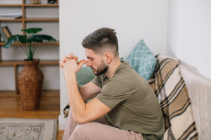 A man sitting clearly disturbed.