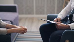 A therapist going through a patient's behavioral patterns noted down