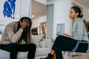 a man overwhelmed at therapy in front of a therapist