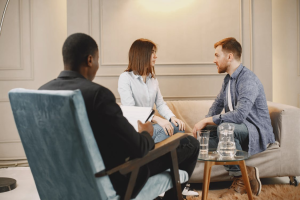 a couple talking in front of a therapist