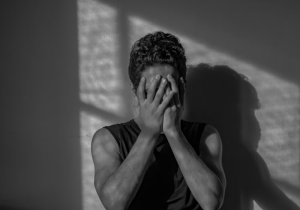 A man covering his face with his hands in shame