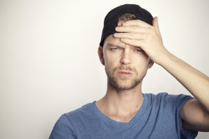 A man holding his head